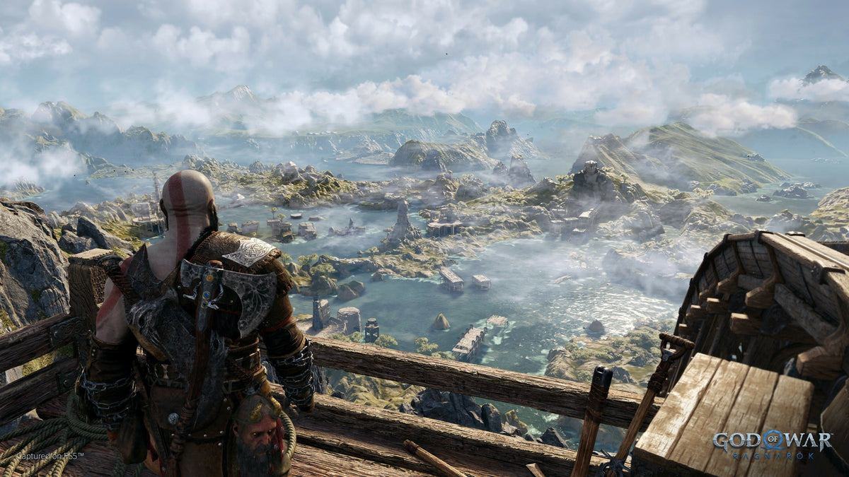 Kratos and Atreus overlooking a vast Norse landscape in God of War: Ragnarök